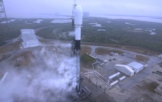 A veteran SpaceX Falcon 9 rocket stands atop Space Launch Complex 40 of the Cape Canaveral Space Force Station in Florida during the attempted launch of 143 satellites on the the Transporter-1 rideshare mission on Jan. 23, 2021. Bad weather delayed the launch.