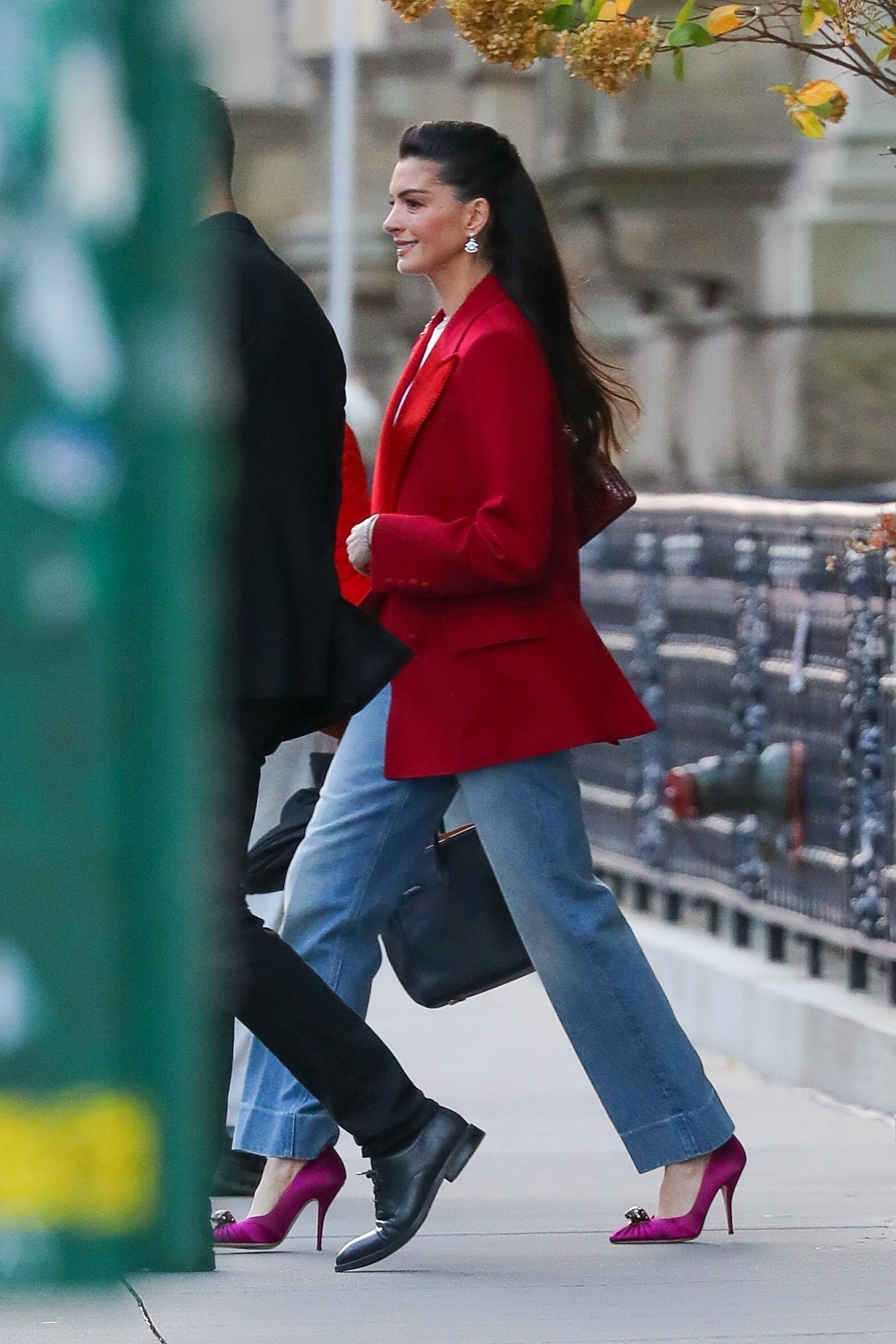 Anne Hathaway was spotted in NYC wearing light-wash jeans, a bright red blazer, and fuchsia pumps, a most interesting color combination