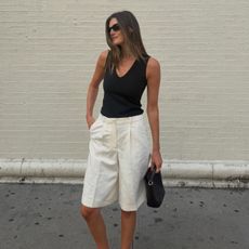 Influencer wearing white bermuda short and black tank top