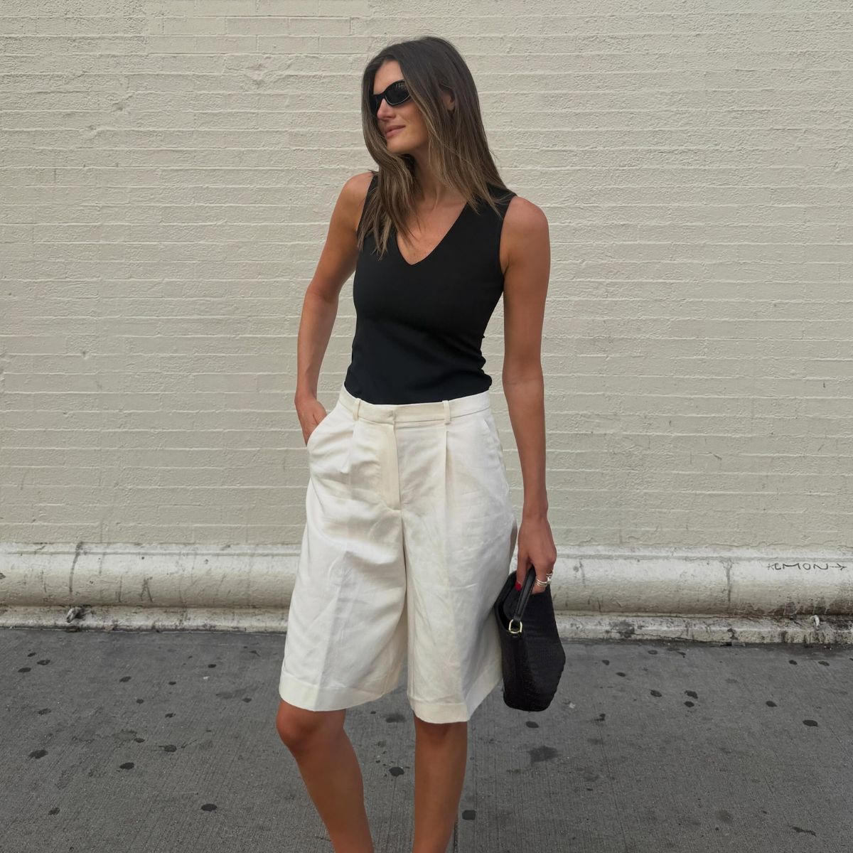Influencer wearing white bermuda short and black tank top