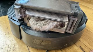 A large clump of hair stuck in the iRobot Roomba Combo 10 Max's onboard bin