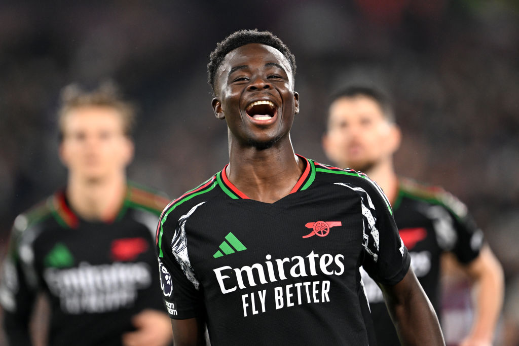 Bukayo Saka of Arsenal celebrates scoring his team's fifth goal from a penalty kick during the Premier League match between West Ham United FC and Arsenal FC at London Stadium on November 30, 2024 in London, England.