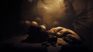 Giant baby monster peering over a rocky ledge in Little Nightmares 3