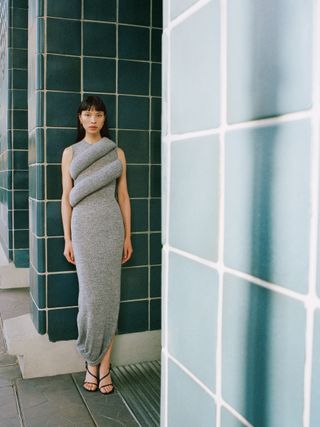 A Net-a-Porter image of a model in a grey, sleeveless, jersey, midaxi dress