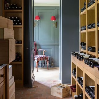 grey blue wine cellar with wooden storage units