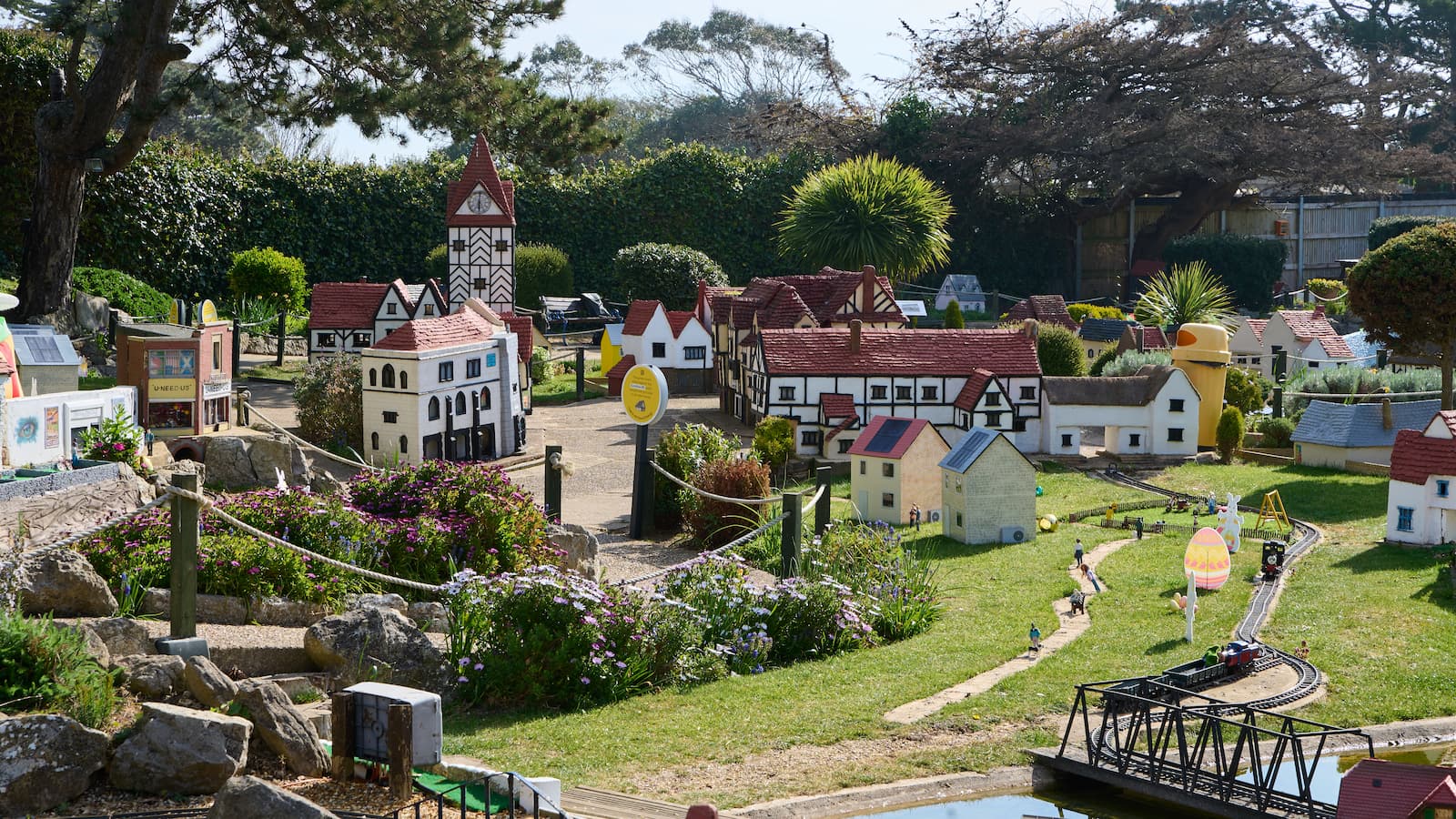 A miniature village showcasing energy efficient tiny homes with tiny figurines