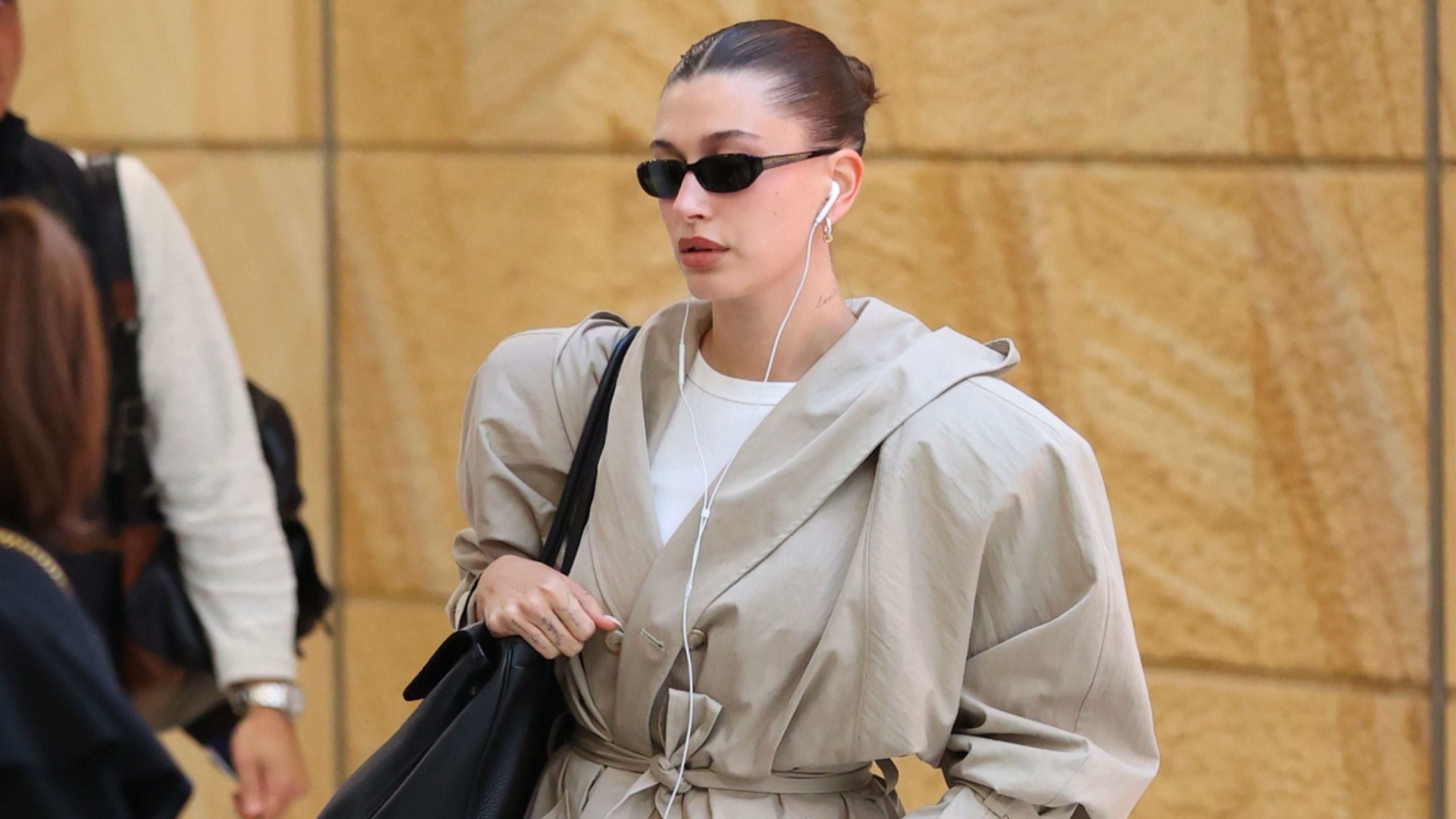 Hailey Bieber wearing a tan coat.