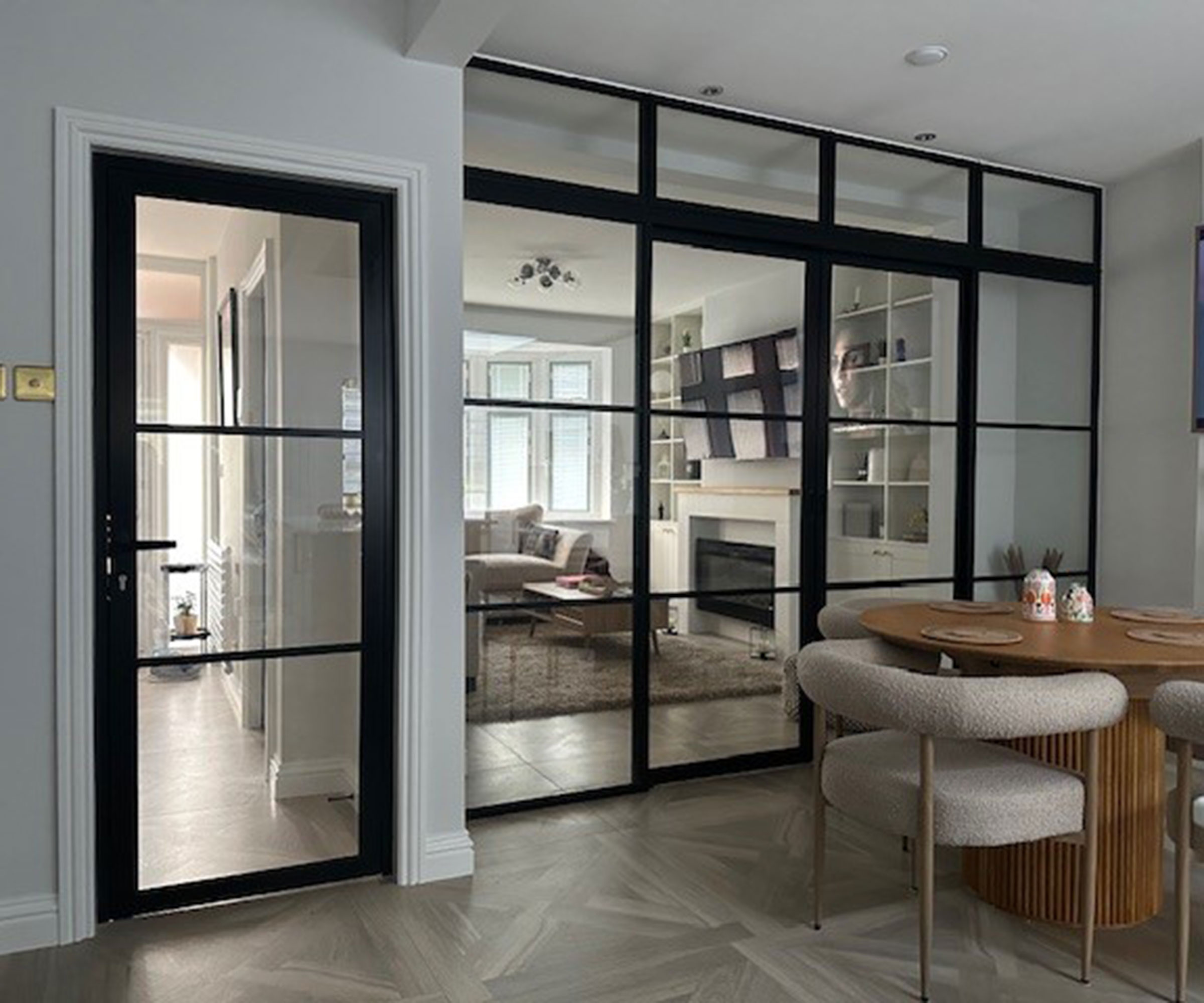 glazed internal doos separating a dining area from a hallway and living room