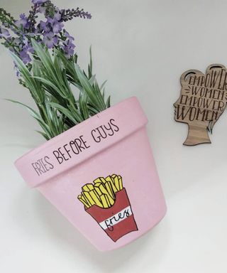 Plant pot painted pink with a french fries motif