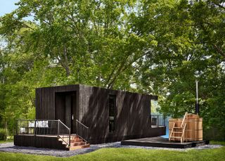 dark clad tiny house on the waterfront