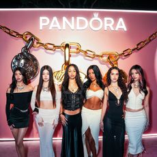 katseye poses in front of pandora sign