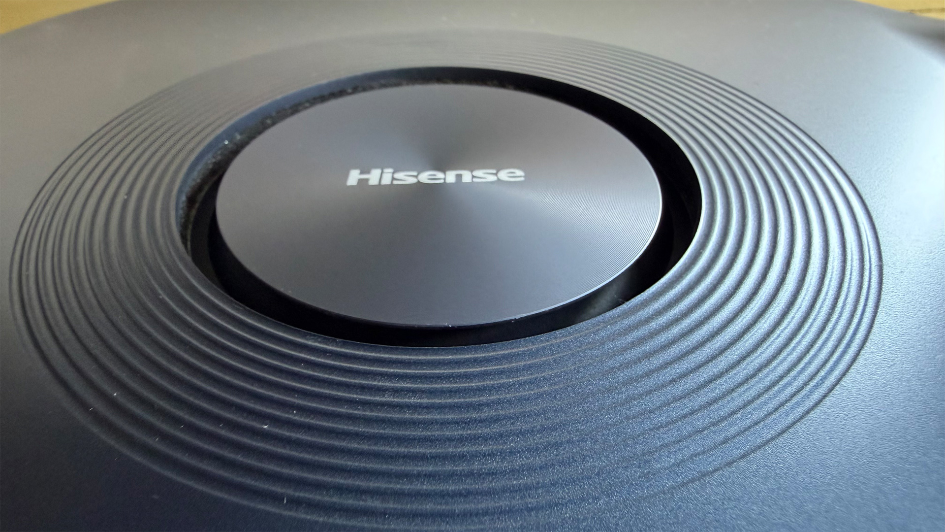 Hisense C2 Ultra home cinema projector close up on upfiring speaker and Hisense logo