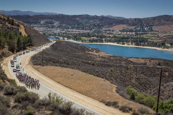 The peloton begins the climb up past Castaic Lake.