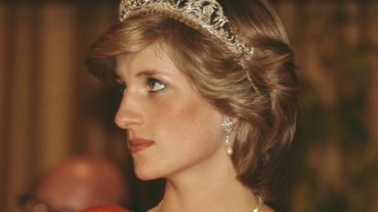 Princess Diana's bulimia struggles appear apparent in photo of her face looking thin. She is wearing the Spencer family tiara and pearl and diamond earrings which were a gift from the Emir of Qatar.