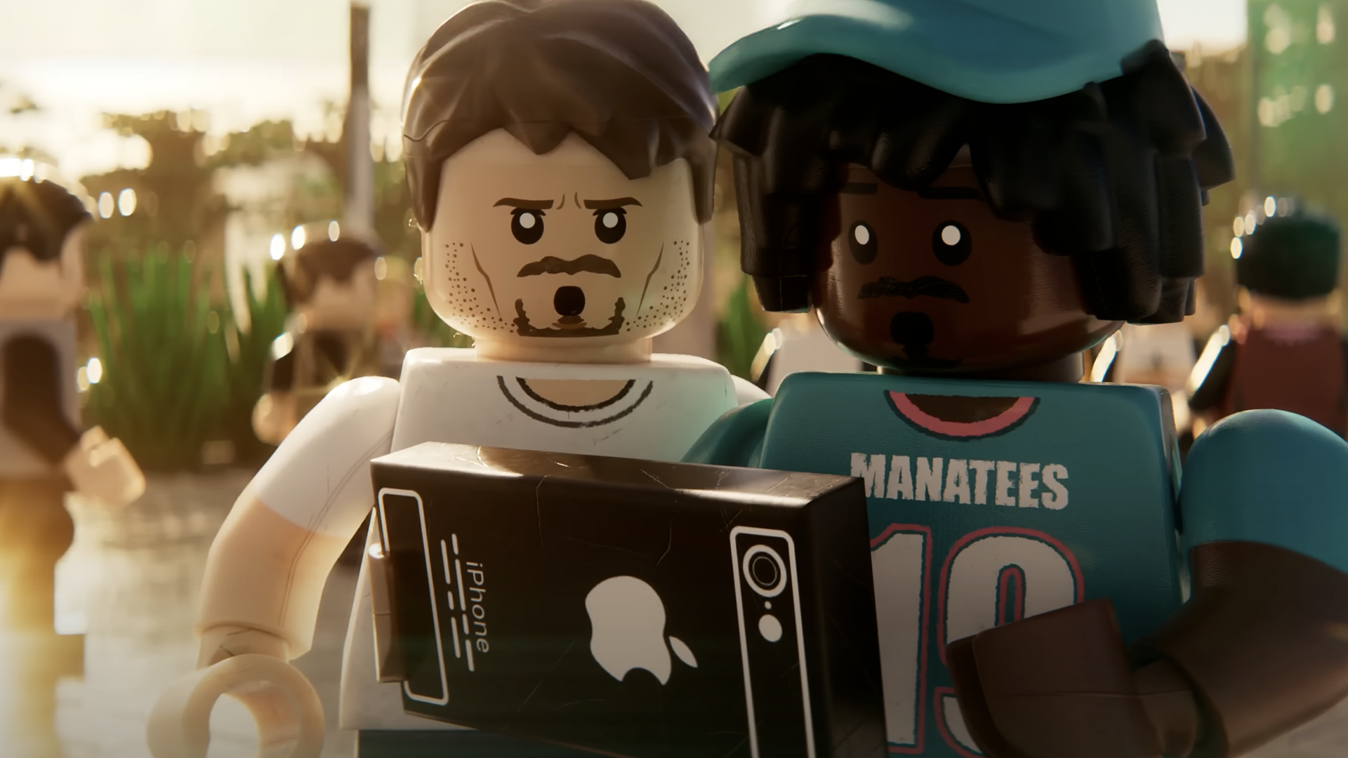 Still taken from fan made Lego GTA 6 trailer – two characters looking at a Lego iPhone in a bright, sunny street