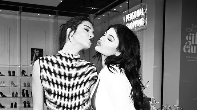 Kendall and Kylie Jenner pose together in a clothing shop