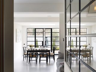 Metal framed windows used as an interior and exterior wall with a concrete floor