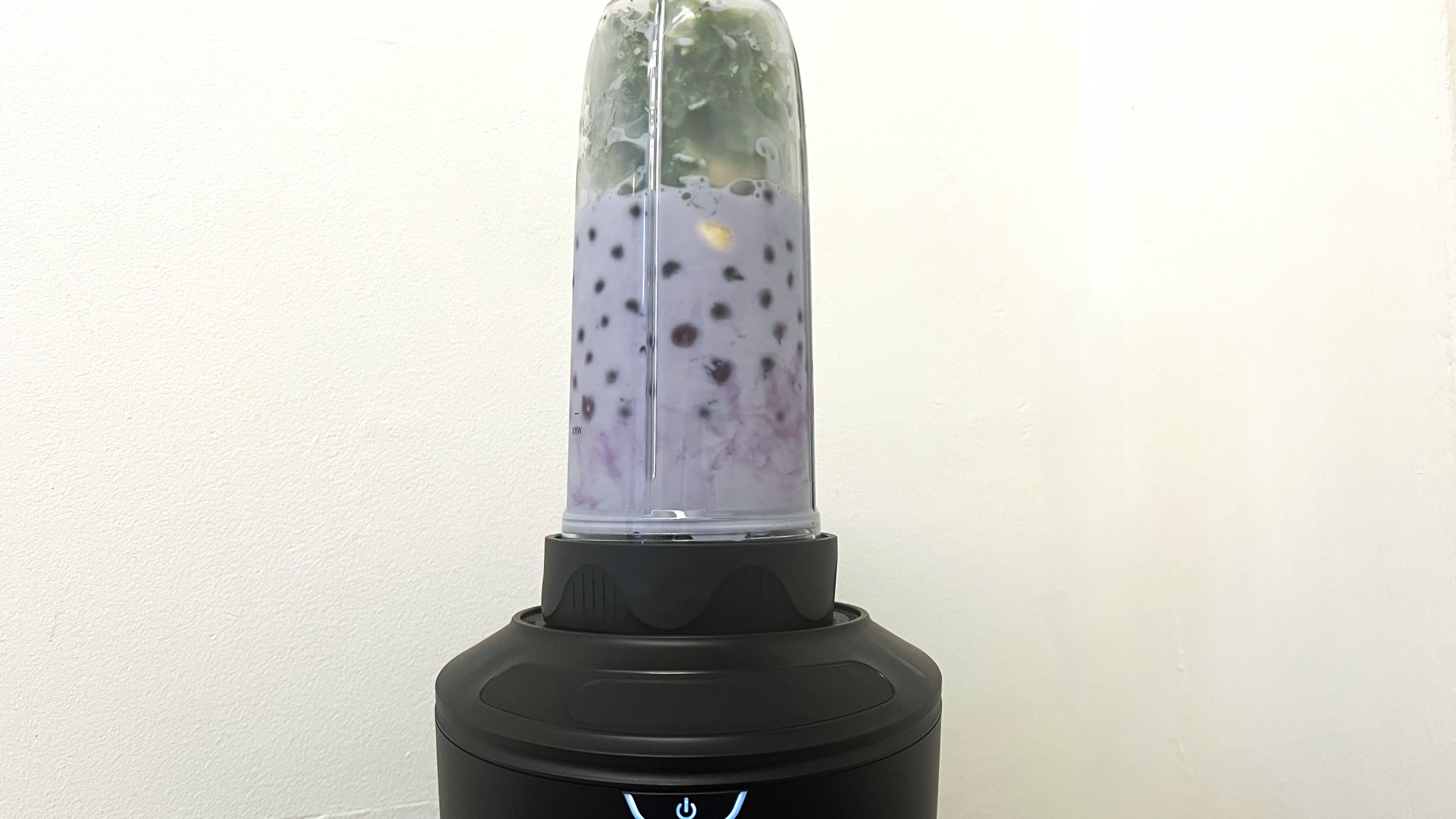 Smoothie ingredients inside Nutribullet SmartSense Blender