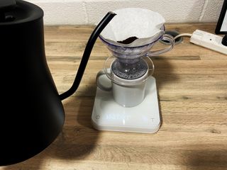 the acaia pearl s coffee scale in use with a hario v60 and a fellow stagg kettle