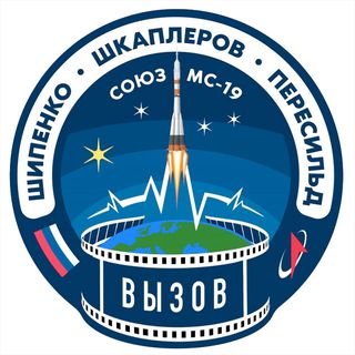 The Soyuz MS-19 crew patch includes a film reel and EKG pattern as nods to the movie that will be shot in space.