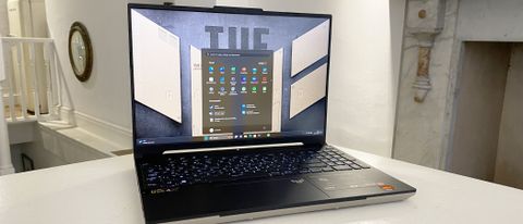 Asus TUF A16 laptop open on a white desk
