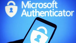 Microsoft Authenticator logo on smarthpone in front of blue background with &#039;Microsoft Authenticator&#039; written in white