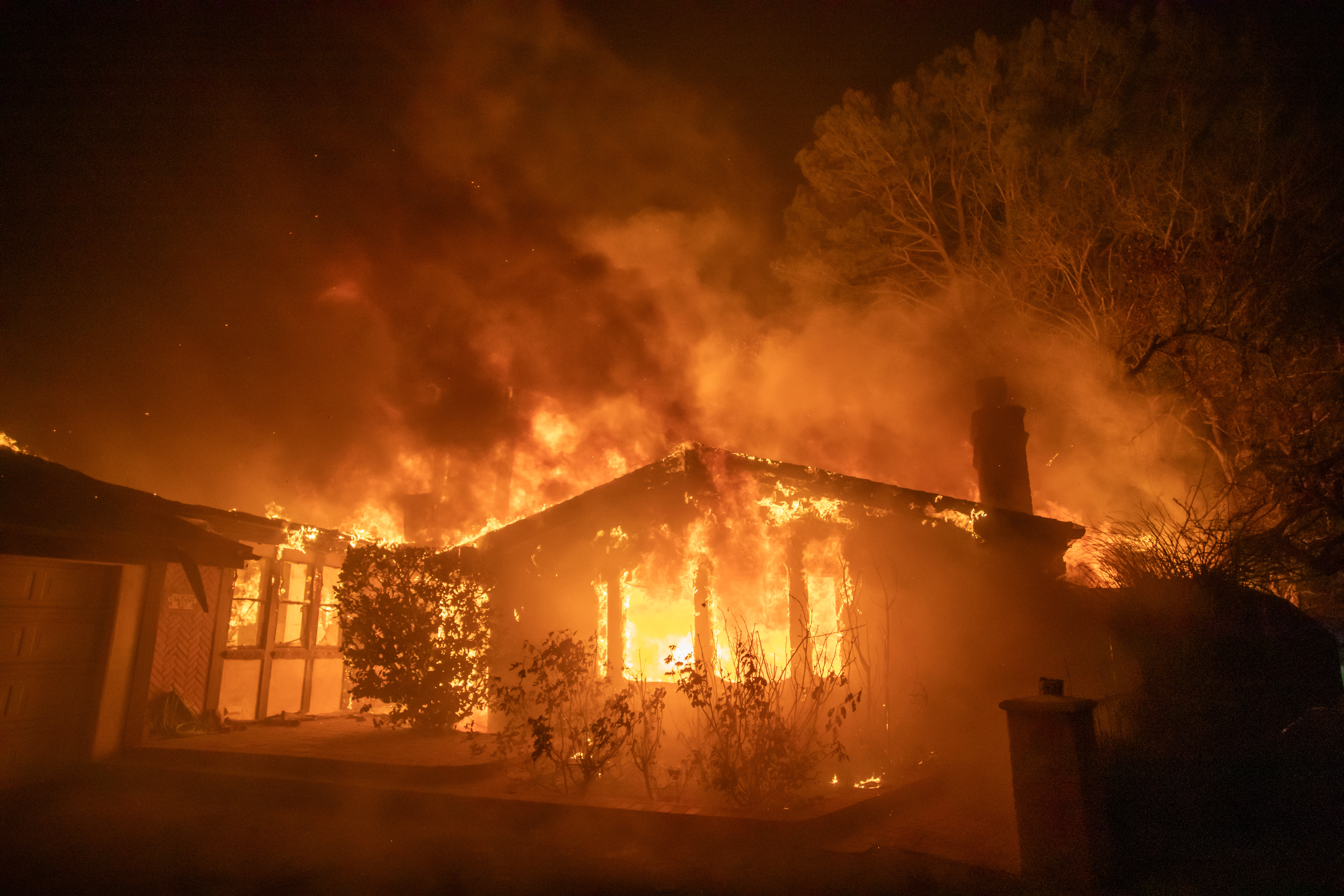 Flames from the Palisades Fire burns a home during a powerful windstorm on January 8, 2025 in the Pacific Palisades neighborhood of Los Angeles, California.