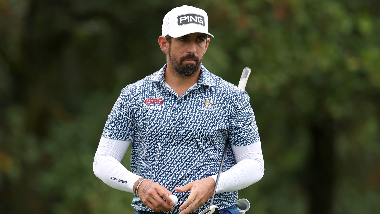 Matthieu Pavon walks off the green holding a putter
