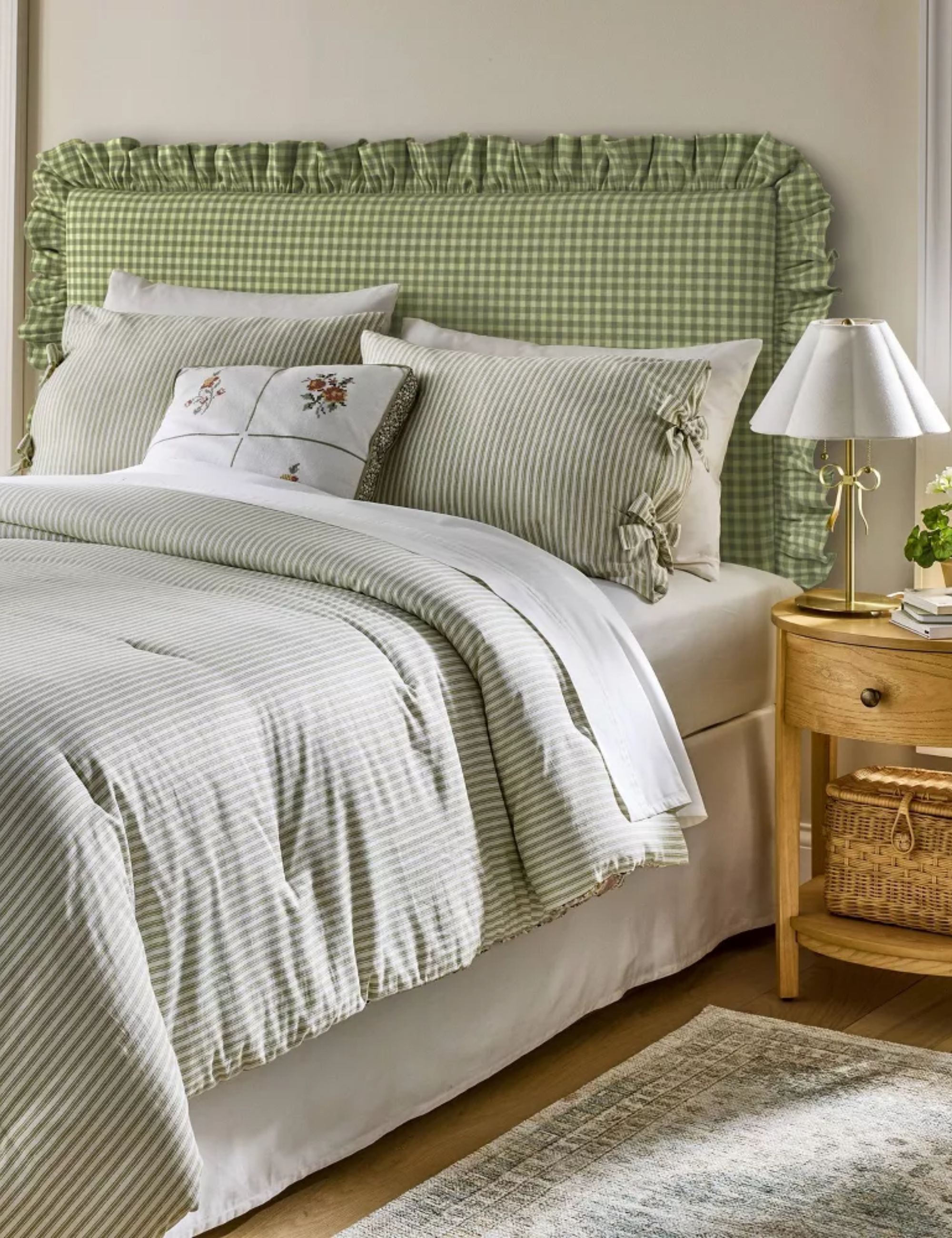 Gray bedroom featuring a green ruched gingham headboard and pinstriped bedding