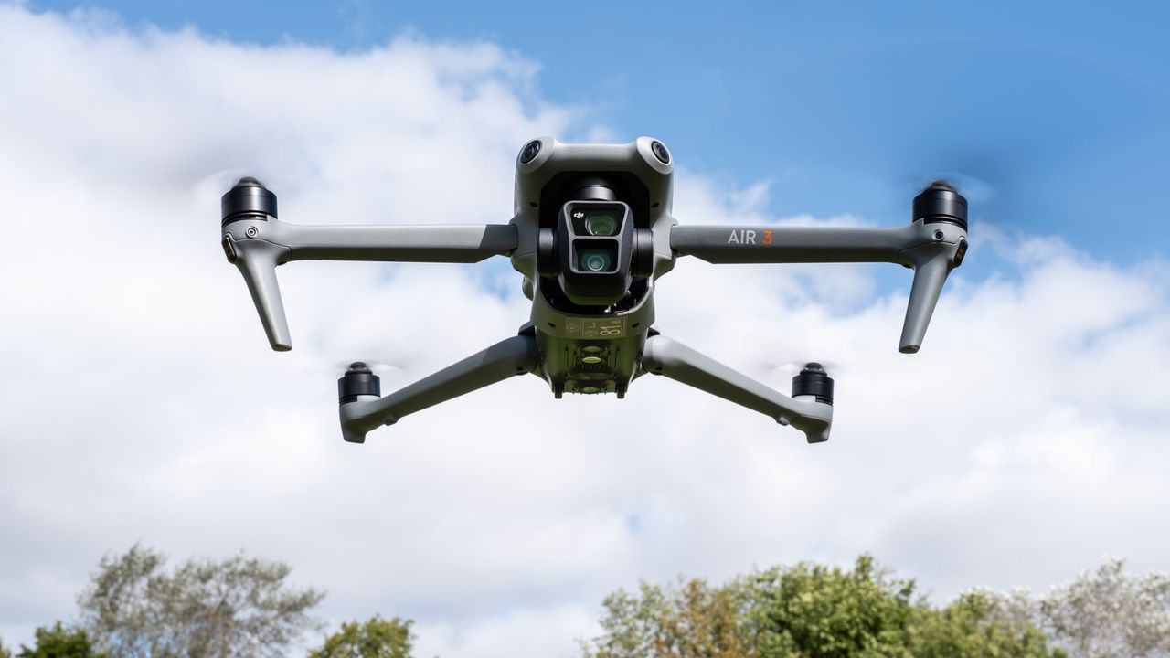 DJI Air 3 drone hovering against a blue sky