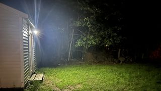 Arlo Essential Outdoor Cam XL on shed at night