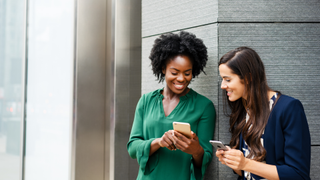 Women holding phones and talking