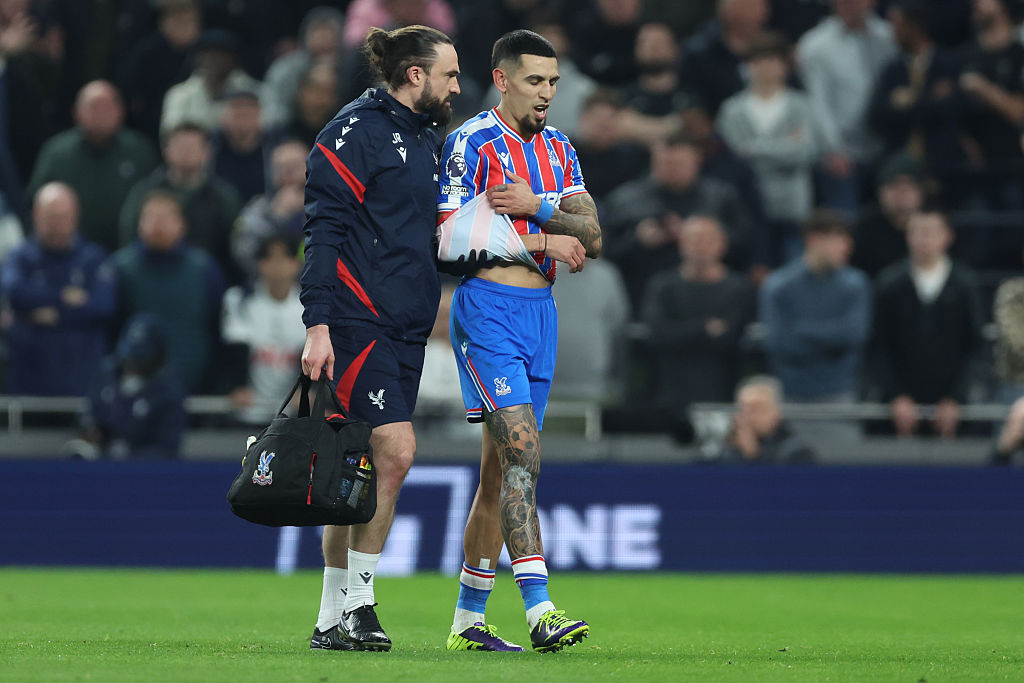 Daniel Munoz leaves the field with a shoulder injury after an awkward landing against Tottenham