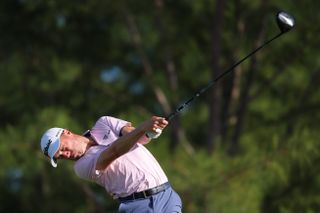 Justin Thomas strikes a ball off the tee