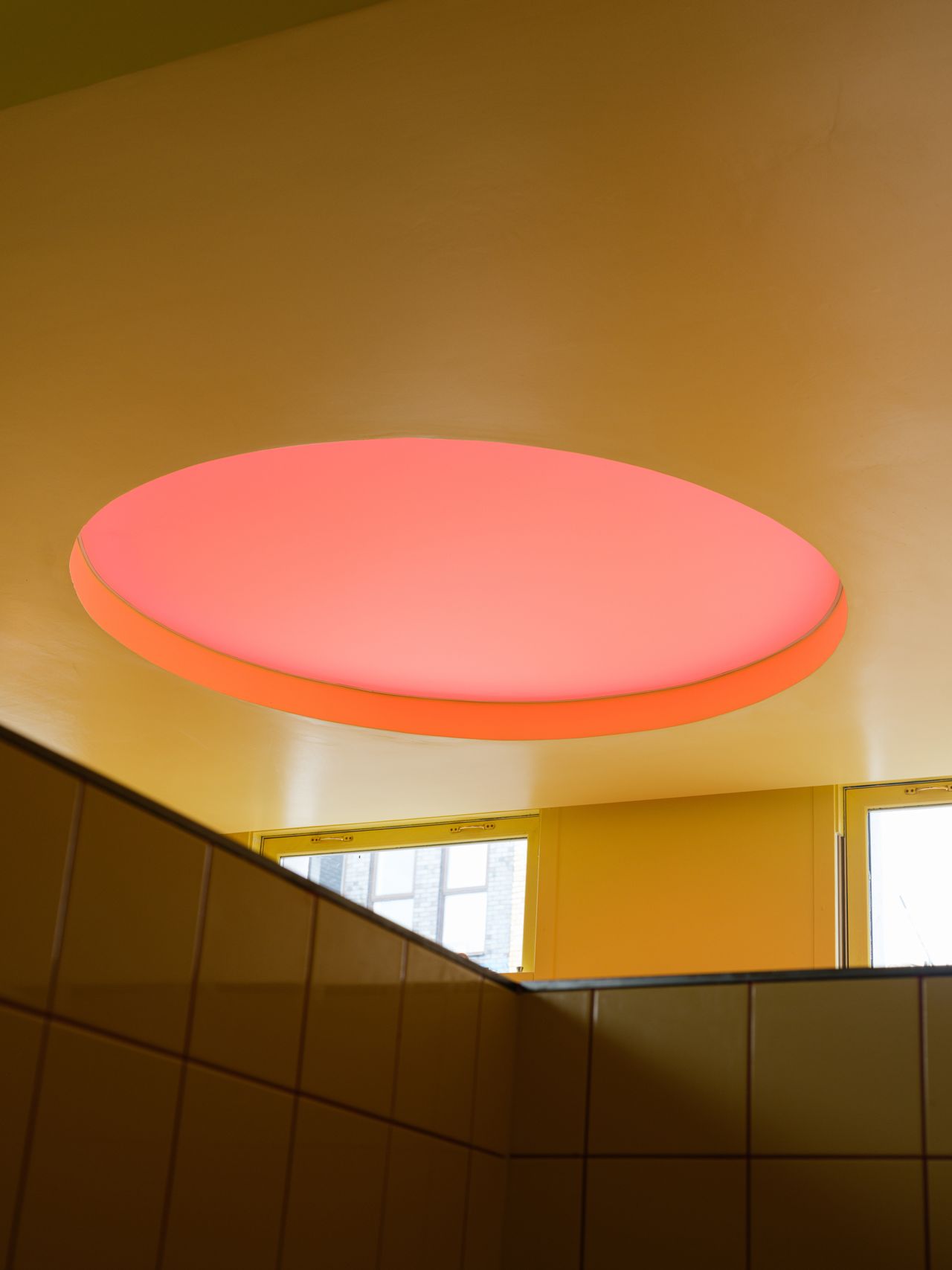 A creatively designed restaurants blends buttery walls with bold accents like lacquered red chairs and floors, porthole-like ceiling lights, spherical sconces, and chrome decor.