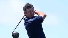 Rory McIlroy hitting a driver at Shinnecock Hills ahead of the 2026 US Open
