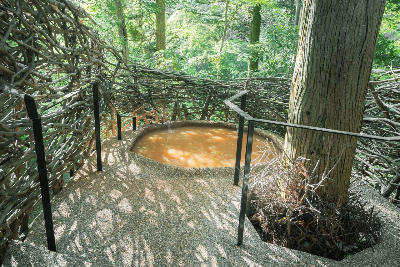 A luxury Japanese hotel boasting warmly lit interiors and traditional decor while being totally immersed in nature.