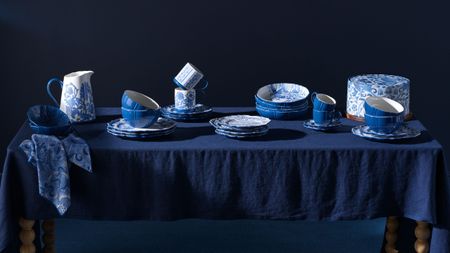 blue room with table set with blue tablecloth and covered in Habitat x Morris & Co blue-and-white tableware