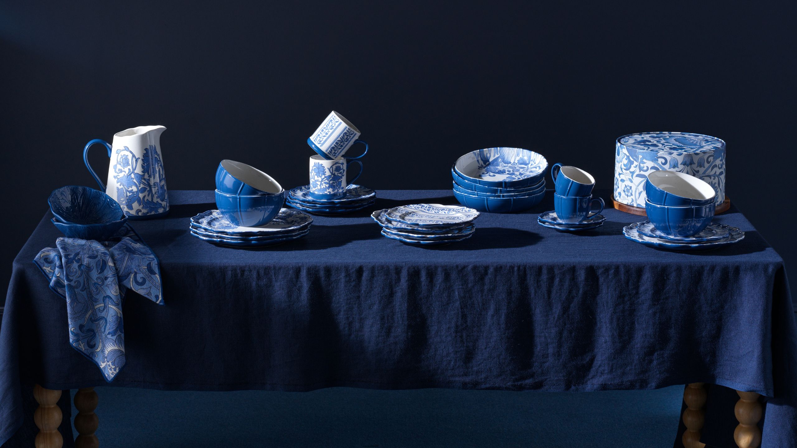 blue room with table set with blue tablecloth and covered in Habitat x Morris &amp; Co blue-and-white tableware