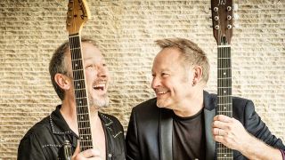 Cutting Crew holding guitars laughing