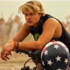 Rudy Pankow as JJ, leaning on a motorbike, in episode 401 of Outer Banks.