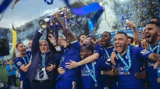 Leicester City players and manager Claudio Ranieri celebrate with the Premier League trophy after their match against Everton in May 2016.