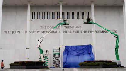 Workers add President Donald Trump&rsquo;s name to the exterior of the Kennedy Center in Washington, D.C. 