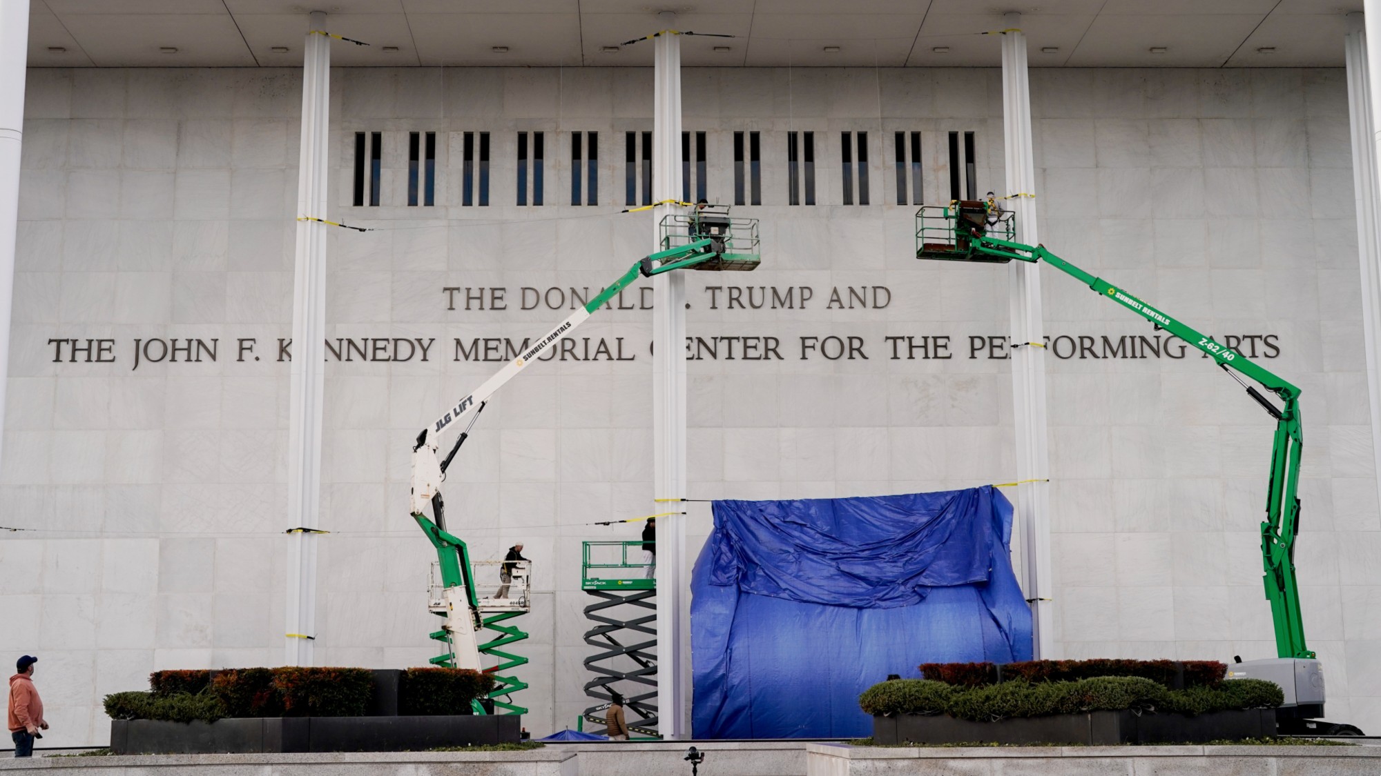 Workers add President Donald Trump&rsquo;s name to the exterior of the Kennedy Center in Washington, D.C. 