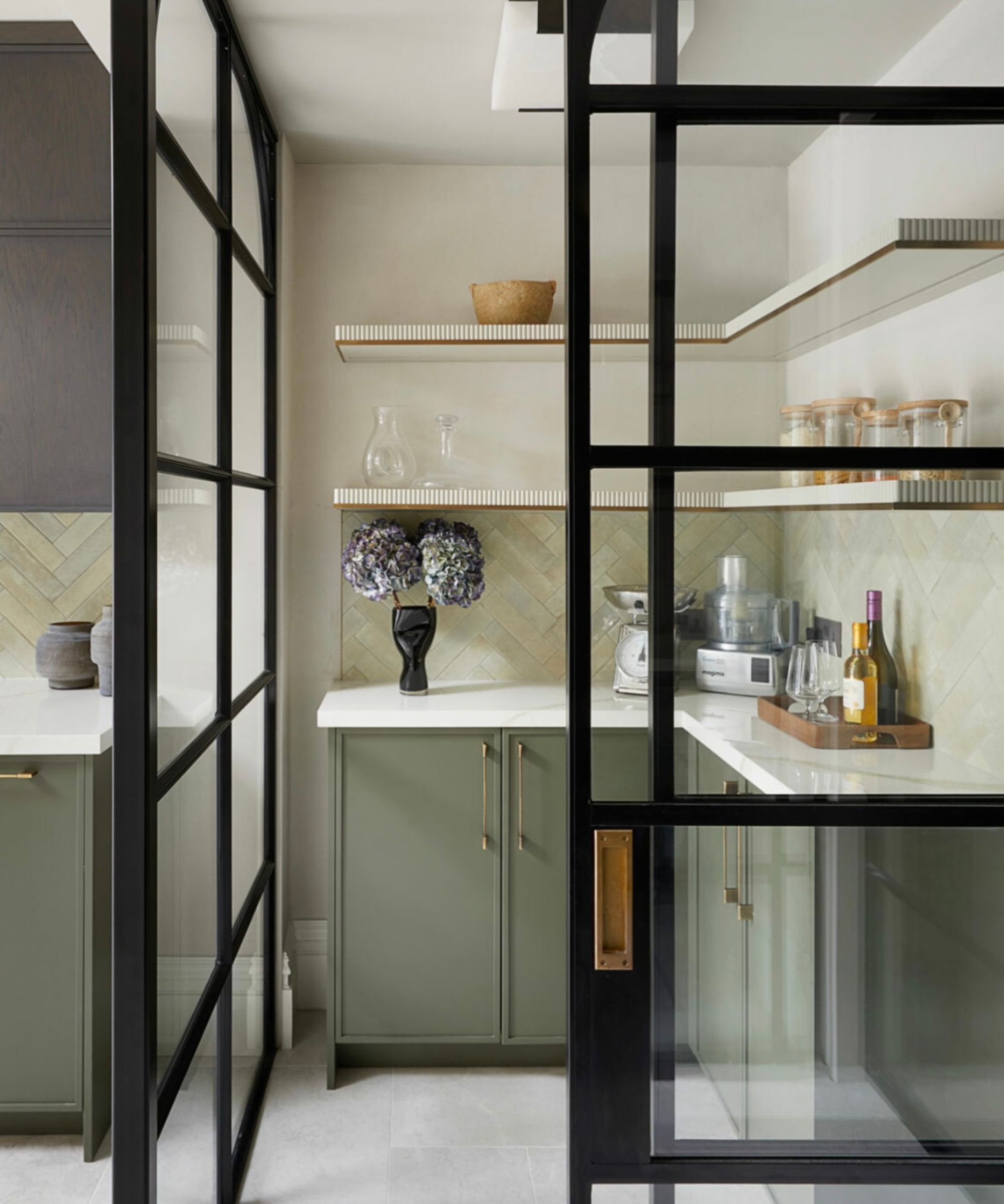 Pantry with Crittall doors, green cabinets and white colored countertop