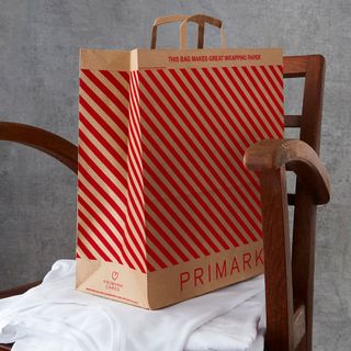 paper bag with armchair and grey background