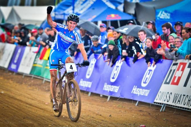 Gerhard Kerschbaumer of Italy punches the air as he claims the win in under 23 men's cross country