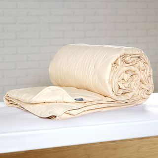 Deluxe Washable Wool Comforter on a counter against a white wall.