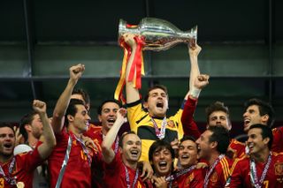 Iker Casillas lifts the European Championship as Spain players celebrate their win over Italy in the final of Euro 2012.