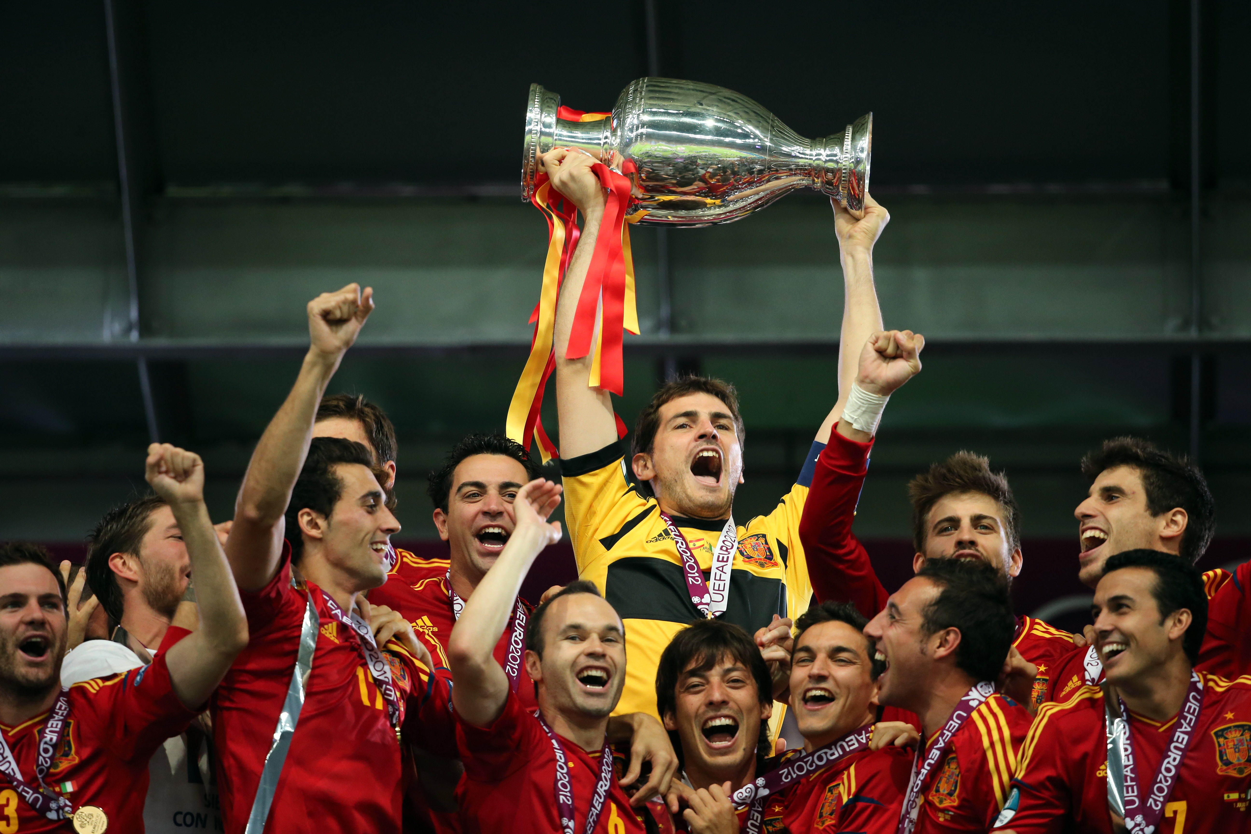 Iker Casillas lifts the European Championship as Spain players celebrate their win over Italy in the final of Euro 2012.